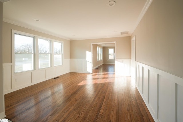 spare room with dark hardwood / wood-style flooring and crown molding