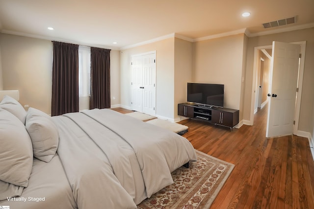 bedroom with dark hardwood / wood-style flooring and ornamental molding