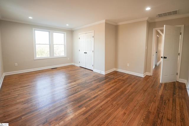 empty room with dark hardwood / wood-style floors and ornamental molding