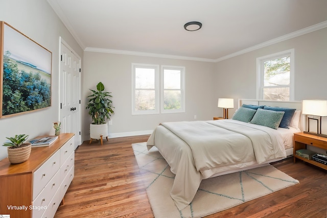 bedroom featuring hardwood / wood-style flooring, a closet, and crown molding