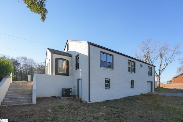 view of home's exterior featuring cooling unit and a garage