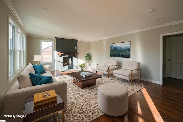 living room with dark hardwood / wood-style floors, crown molding, and a fireplace