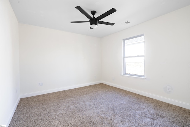 carpeted spare room featuring ceiling fan