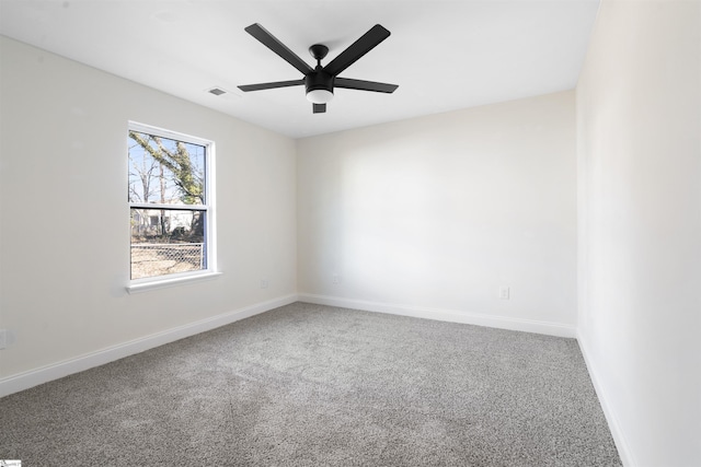 carpeted spare room featuring ceiling fan