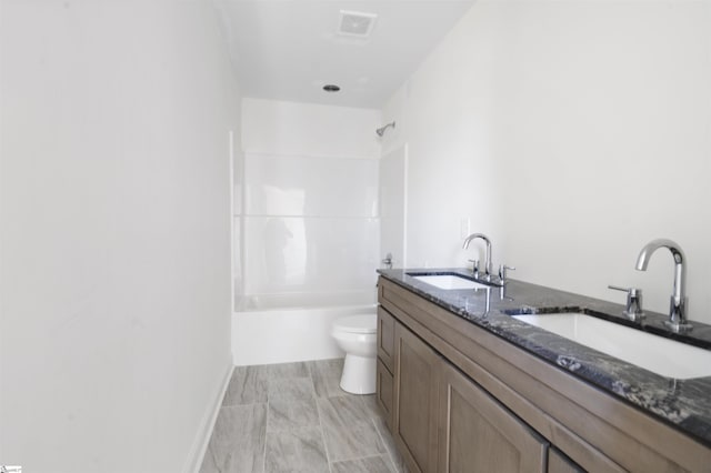 full bathroom featuring toilet, vanity, and bathing tub / shower combination