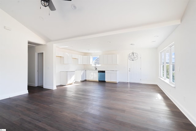 unfurnished living room featuring vaulted ceiling, dark hardwood / wood-style flooring, ceiling fan with notable chandelier, and sink