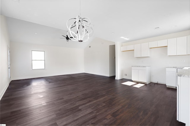 unfurnished living room with vaulted ceiling, dark hardwood / wood-style flooring, and an inviting chandelier