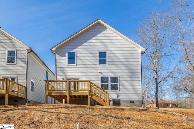 back of property with a deck and cooling unit