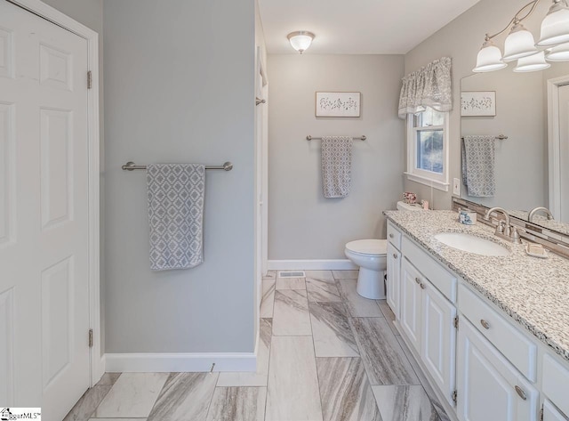 bathroom featuring toilet and vanity