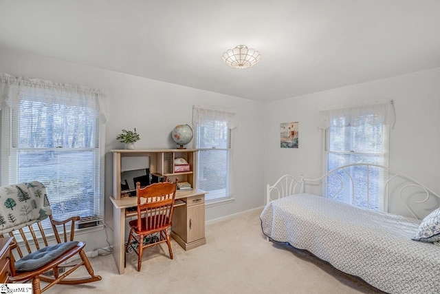 carpeted bedroom featuring multiple windows