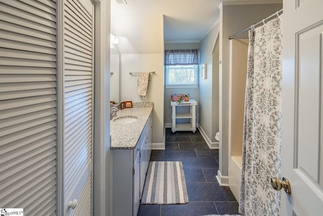 bathroom with toilet, vanity, and crown molding