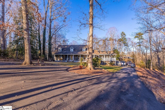 view of front of property featuring a porch and a carport