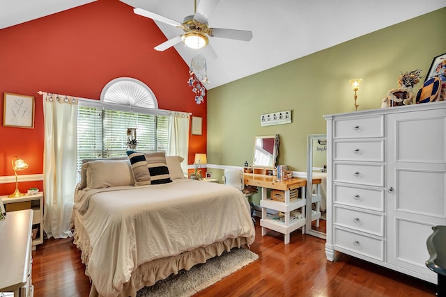 bedroom with ceiling fan, dark wood-type flooring, and high vaulted ceiling