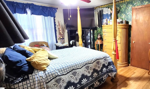 bedroom with ceiling fan and hardwood / wood-style flooring