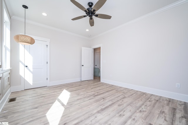 empty room with recessed lighting, visible vents, baseboards, light wood finished floors, and crown molding