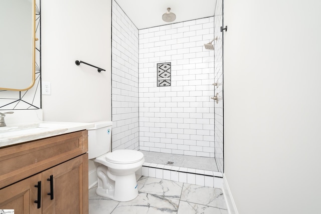 full bath with toilet, vanity, baseboards, marble finish floor, and tiled shower