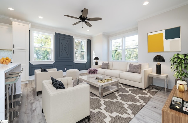 living room featuring plenty of natural light and crown molding