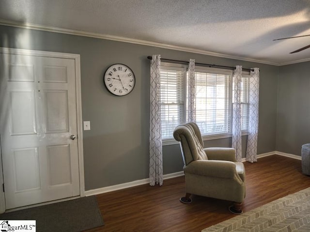 sitting room featuring a textured ceiling, ceiling fan, dark hardwood / wood-style flooring, and ornamental molding