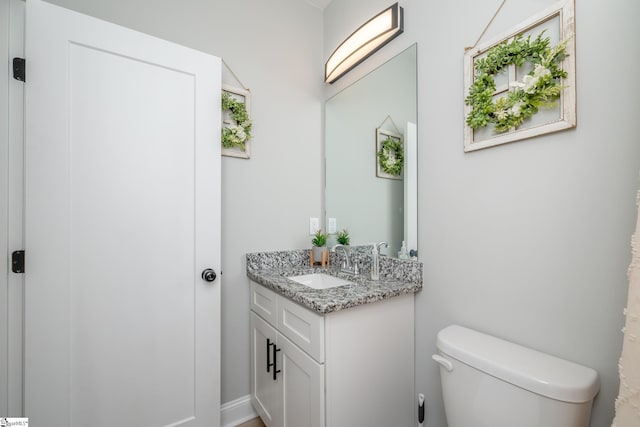 bathroom with toilet and vanity