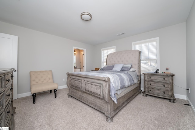 carpeted bedroom with ensuite bathroom