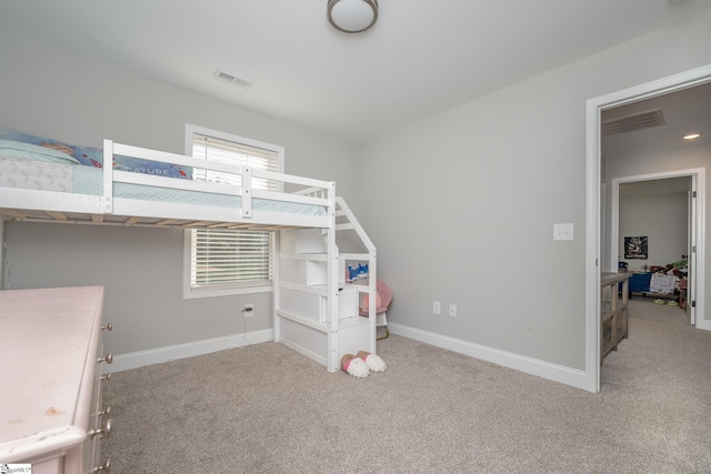 bedroom with light colored carpet