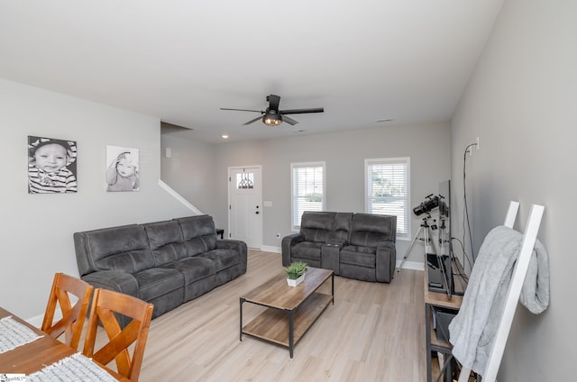 living room featuring ceiling fan and light hardwood / wood-style flooring