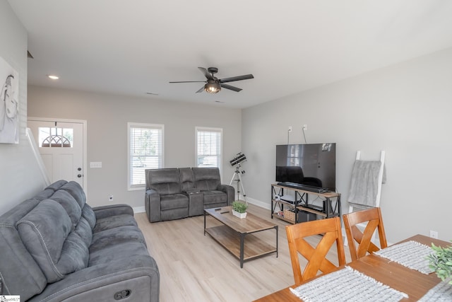 living room featuring ceiling fan and light wood-type flooring