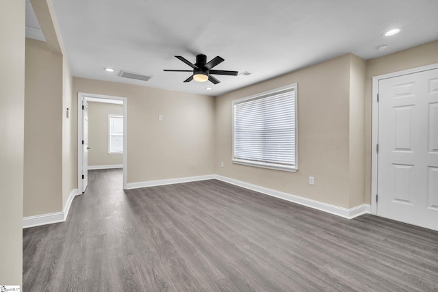 empty room featuring dark wood-type flooring and ceiling fan