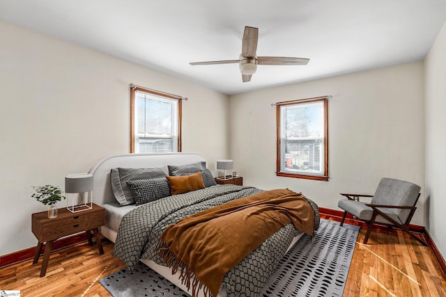 bedroom with light wood-type flooring and ceiling fan