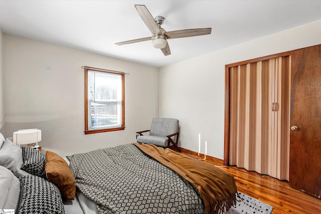 bedroom with ceiling fan and hardwood / wood-style flooring