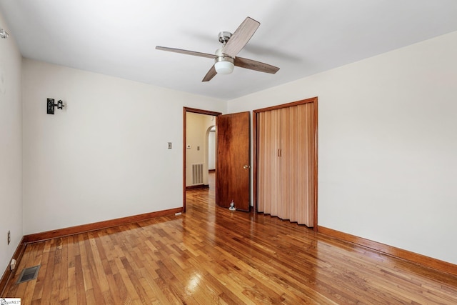 unfurnished bedroom featuring ceiling fan, light hardwood / wood-style flooring, and a closet