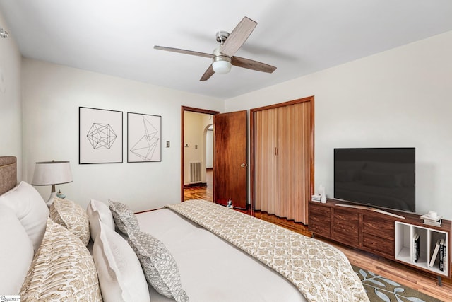 bedroom with ceiling fan and light hardwood / wood-style flooring