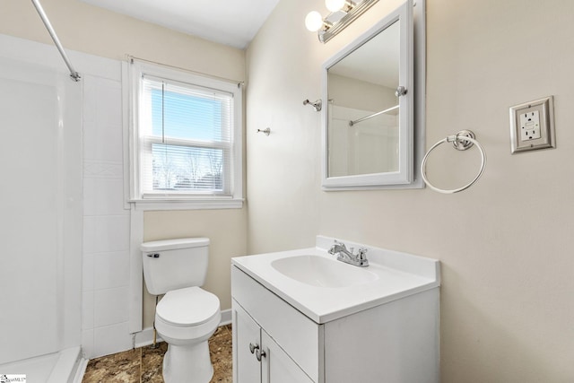 bathroom featuring toilet, vanity, and walk in shower