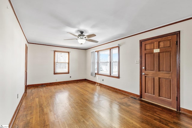 interior space with ceiling fan, ornamental molding, and hardwood / wood-style floors