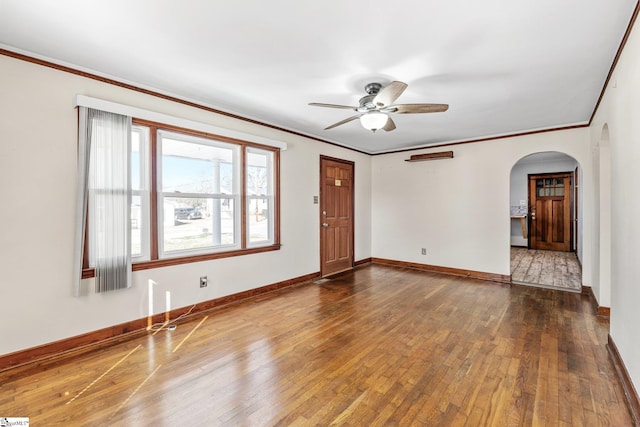 unfurnished room with ceiling fan, dark hardwood / wood-style flooring, and crown molding