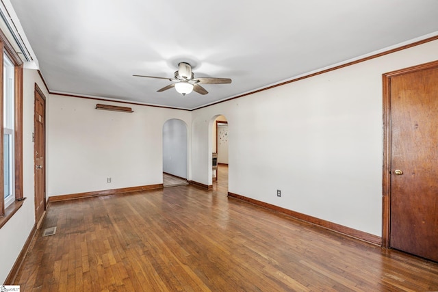 spare room with ceiling fan, dark hardwood / wood-style flooring, and crown molding