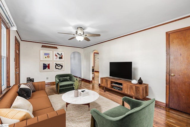 living room featuring ceiling fan, ornamental molding, and hardwood / wood-style flooring