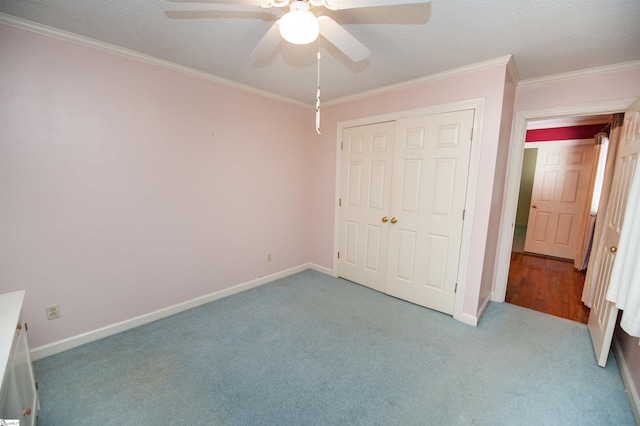 unfurnished bedroom with ceiling fan, ornamental molding, a textured ceiling, light carpet, and a closet