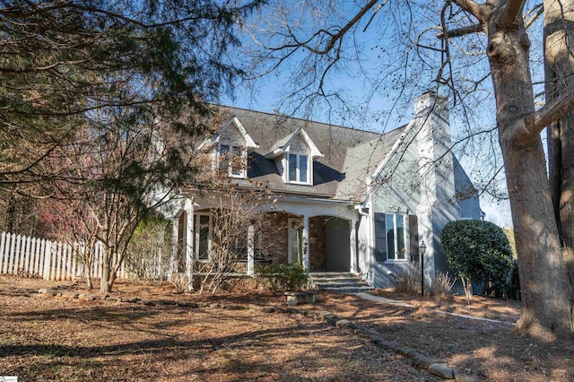 cape cod-style house featuring covered porch