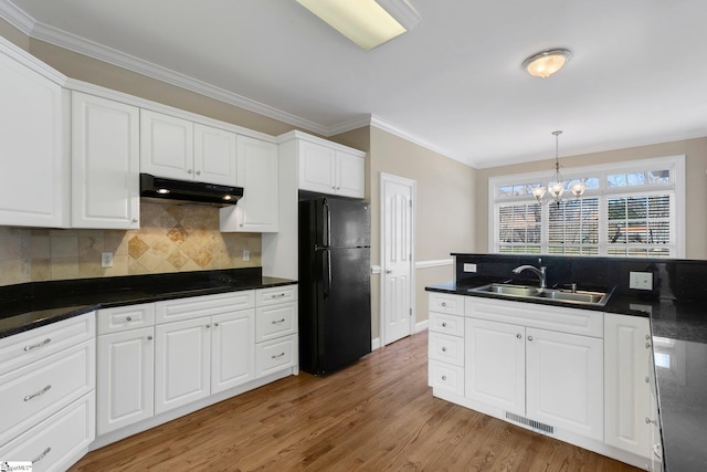 kitchen featuring decorative backsplash, sink, white cabinets, and black appliances