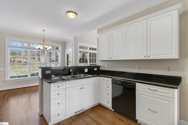 kitchen with kitchen peninsula, black dishwasher, white cabinets, and sink