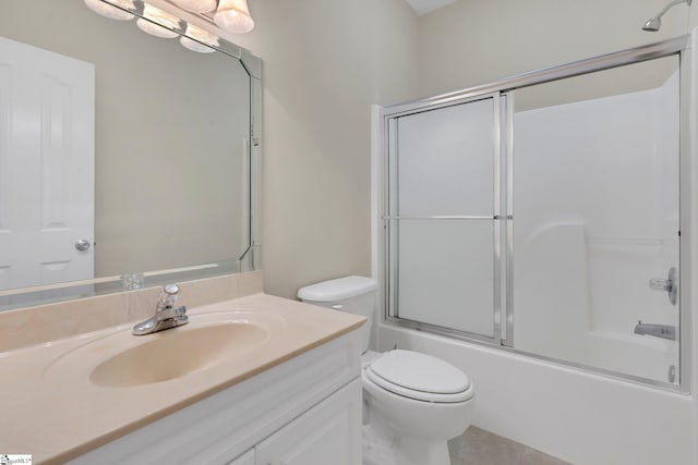 full bathroom with toilet, bath / shower combo with glass door, tile patterned flooring, and vanity