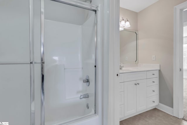 bathroom featuring bath / shower combo with glass door and vanity