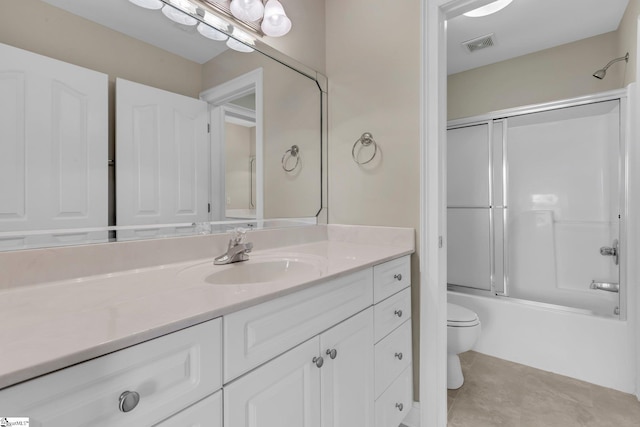 full bathroom featuring toilet, bath / shower combo with glass door, and vanity