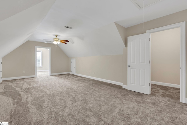 bonus room with ceiling fan, lofted ceiling, and light carpet