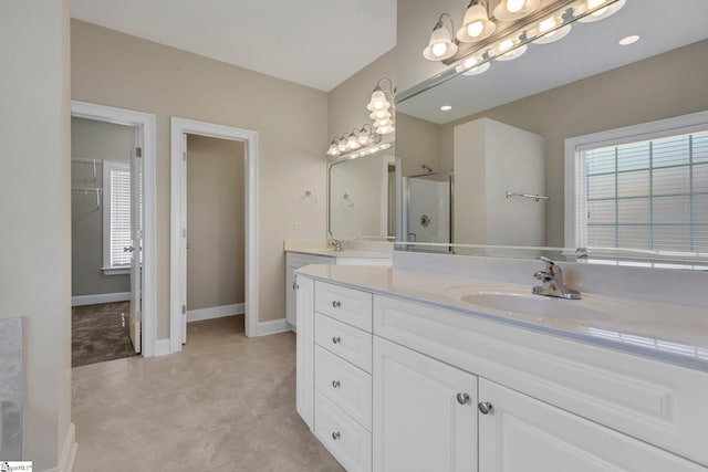 bathroom featuring an enclosed shower and vanity