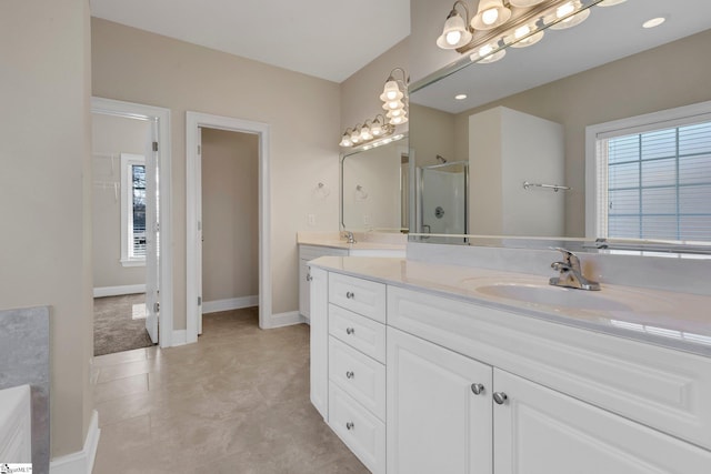 bathroom with vanity and a shower with door