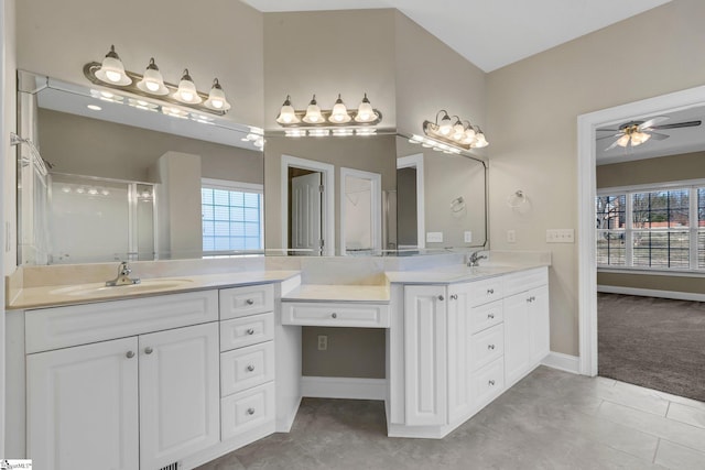 bathroom featuring ceiling fan, plenty of natural light, tile patterned floors, and a shower with door