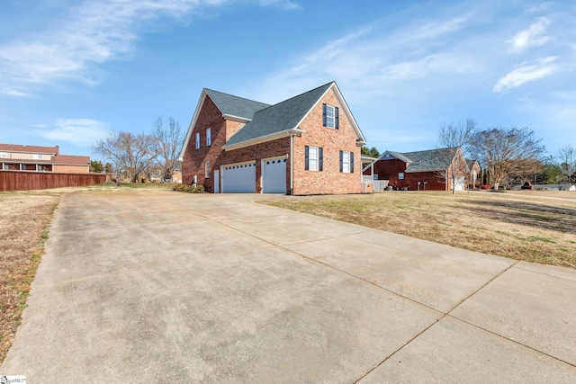 view of home's exterior with a garage and a lawn