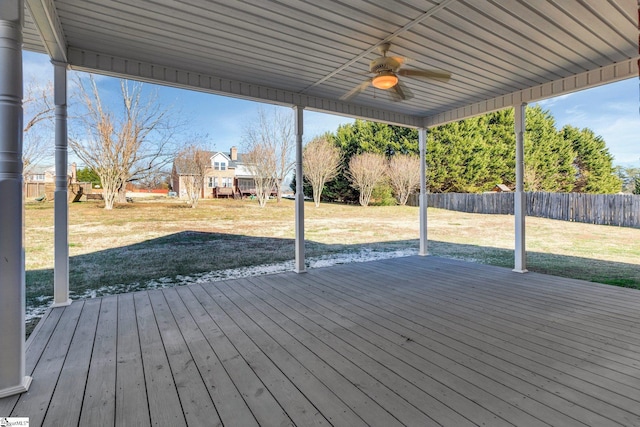 deck featuring ceiling fan and a yard